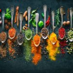 Colourful various herbs and spices for cooking on dark background